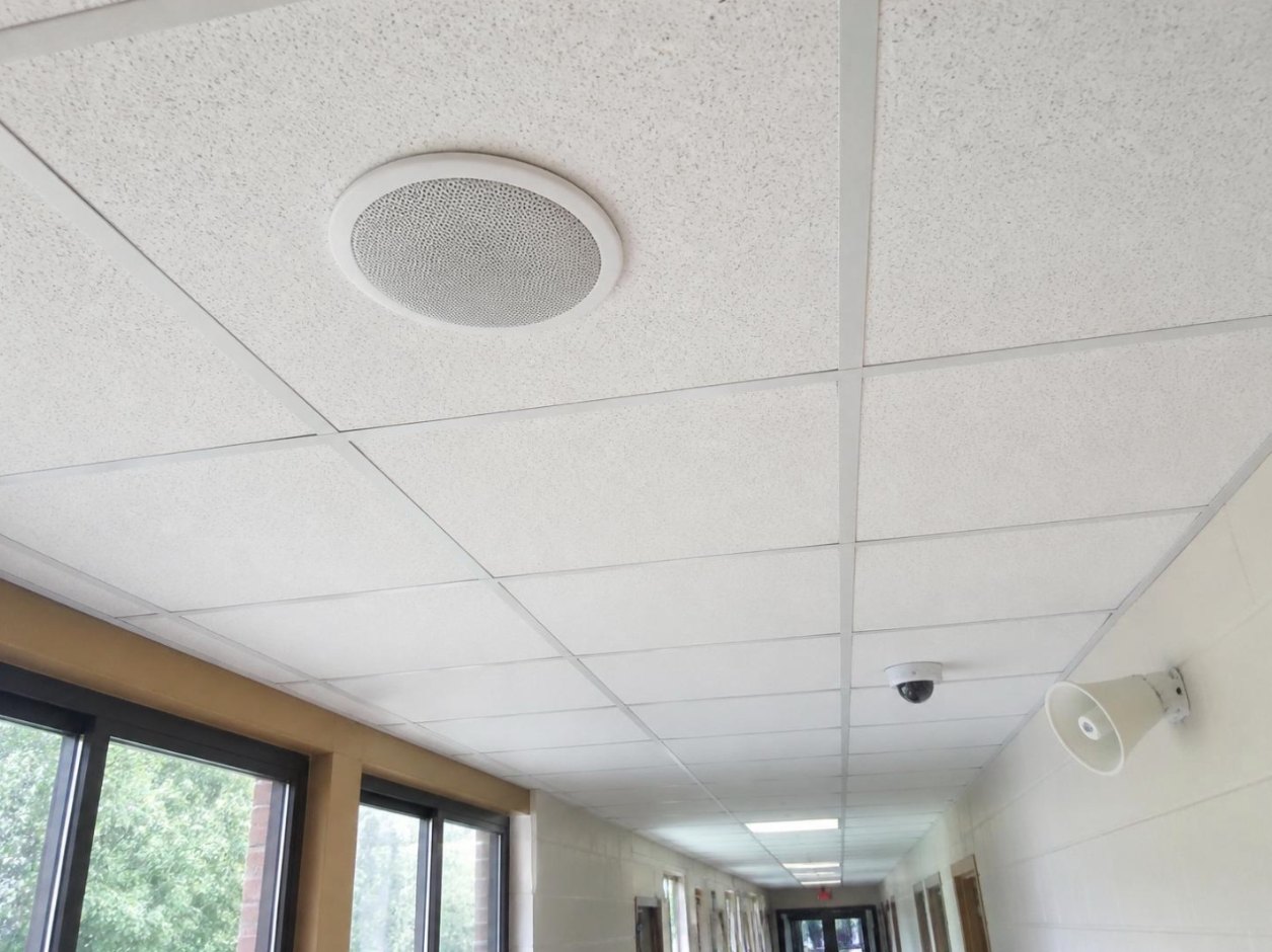 IP ceiling speaker in a school hallway